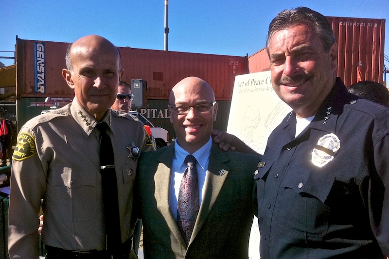 On the stage delivering a speech with Sheriff Leroy Baca (LASD) and Charles L. Beck, Chief of Police of the Los Angeles Police Department (LAPD) at a televised event for the Art of Peace Charitable Trust. (2010)